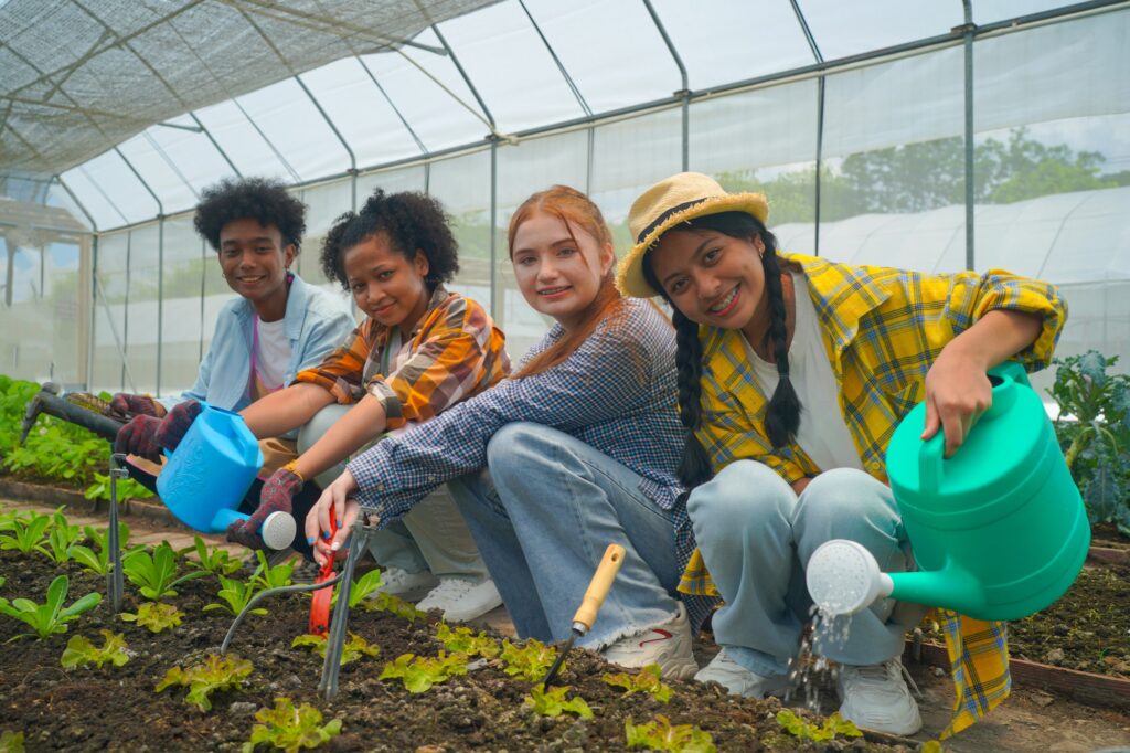 Happy multiracial young farmers working in garden
