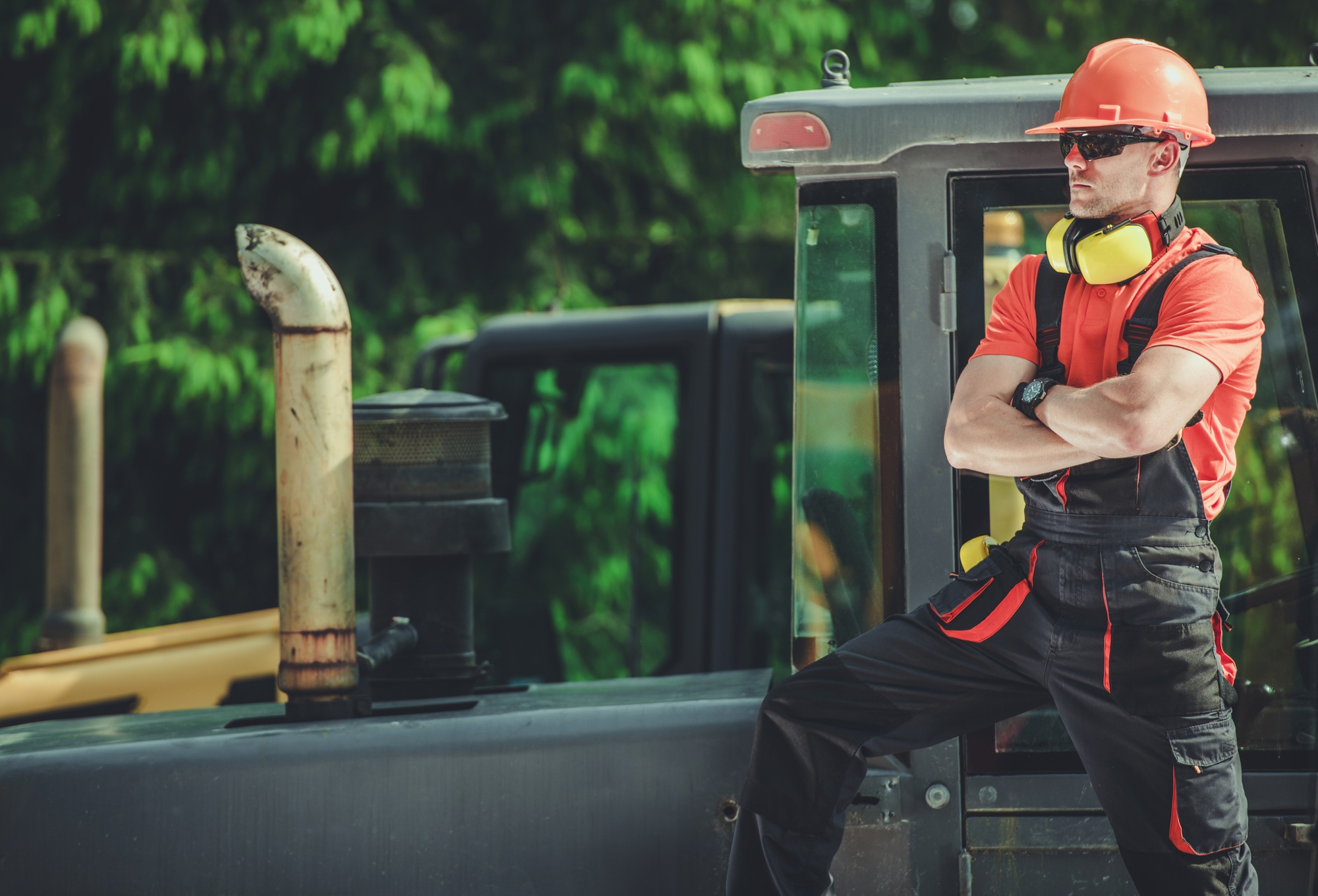 Professional Crawler Operator Next to Heavy Equipment
